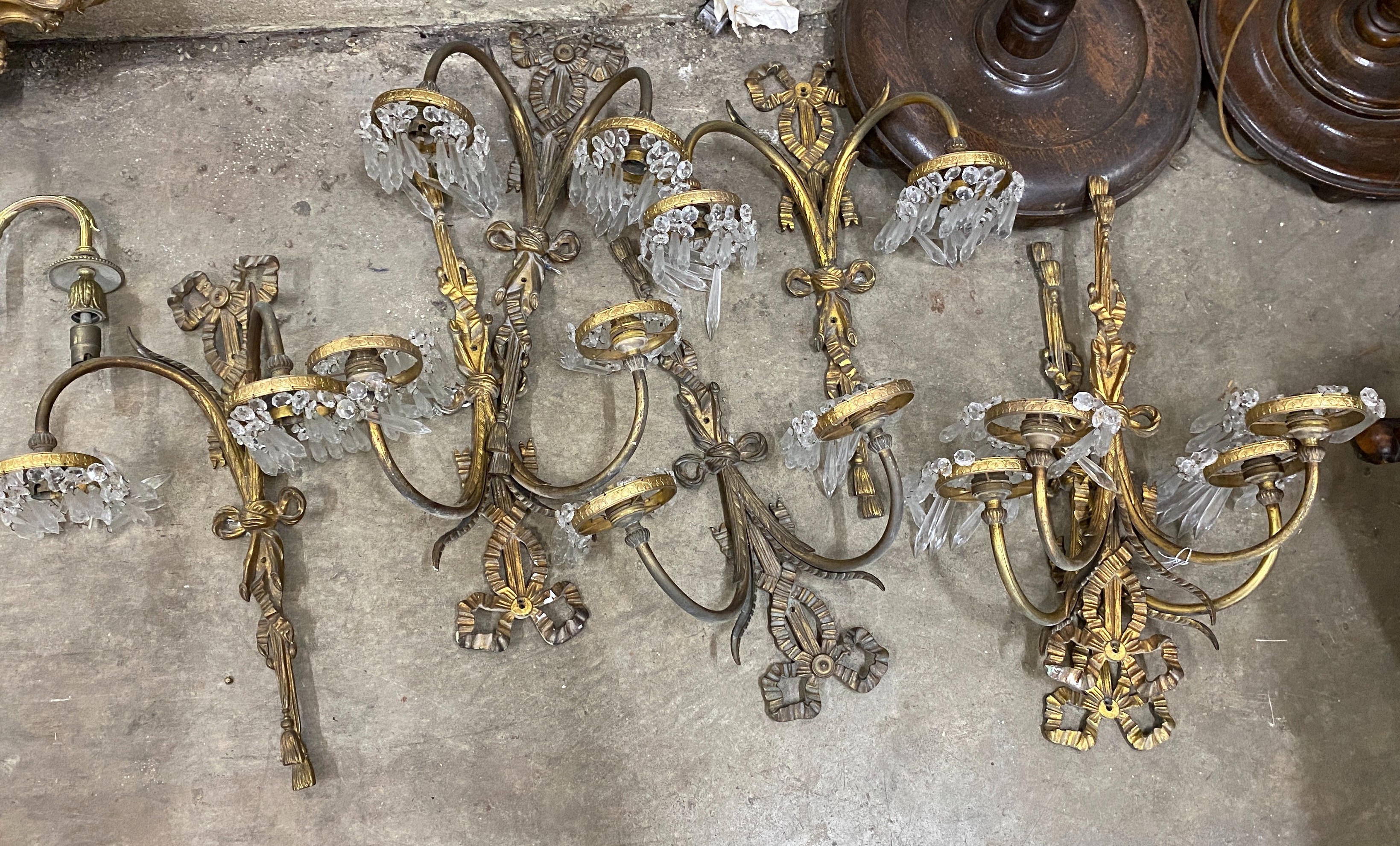 A set of eight gilt metal twin branch lustre wall lights, height 50cm